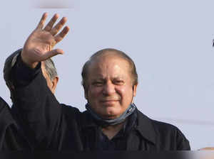 Pakistan's former Prime Minister Nawaz Sharif waves to his supporters as he arri...