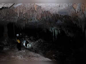 Activists from the group Cenotes Urbanos explore the underground caves of the Aktun T'uyul System, in Playa del Carmen