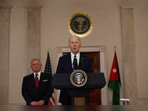 US President Joe Biden speaks to the press as King Abdullah II of Jordan looks on in the Cross Hall of the White House in Washington, DC, on February 12, 2024.