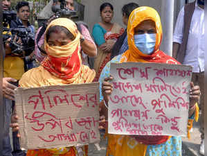 North 24 Parganas, Feb 12 (ANI): Women show posters during the Sandeshkhali visi...