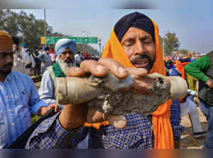 Patiala: A farmer shows a tear gas shell fired by the police to disperse protest...