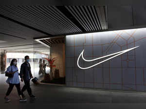 FILE PHOTO: People walk past a Nike Inc store at a shopping complex in Beijing