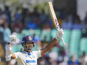 Rajkot: India's Yashasvi Jaiswal raises his bat after scoring his 150 runs durin...