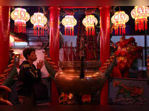 A worshipper prays during the Chinese Lunar New Year's Eve, Year of the Dragon at Amurva Bhumi Temple in Jakarta