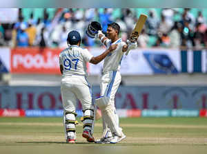India's Yashasvi Jaiswal celebrates with his teammate Sarfaraz Khan (L) after scoring a double century (200 runs) during the fourth day of the third Test cricket match between India and England at the Niranjan Shah Stadium in Rajkot on February 18, 2024.