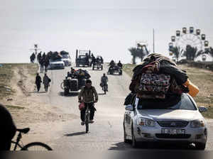Palestinian families fleeing Khan Yunis on the coastal road leading to Rafah further south drive along the sea with their belongings on their cars on January 25, 2024, amid continuing battles between Israel and the Palestinian militant group Hamas.