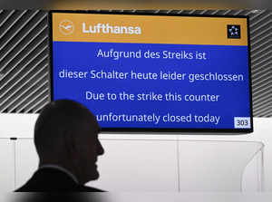 A man stands underneath an information board announcing the booth is closed at German airline Lufthansa during a strike action by ground crews, services staff and security personnel, at Frankfurt's International Airport, western Germany, on early February 20, 2024.