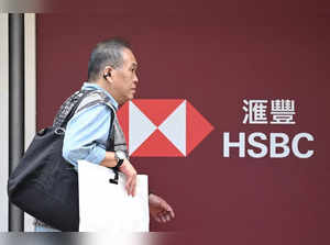 A man walks outside the headquarters of the Hong Kong and Shanghai Banking Corporation Limited (HSBC) in Hong Kong on February 21, 2024.