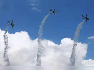 India Air Force's Sarang Aerobatic Team performs in their HAL Dhruv helicopters during an aerial display at the Singapore Airshow