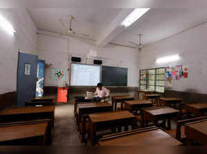 A teacher conducts online classes in an empty classroom after primary schools were ordered shut by the Delhi government for Friday and Saturday as the air quality index (AQI) plummeted, on a smoggy morning in New Delhi