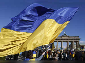 The Ukrainian flag waves as demonstrators take part in a rally in support of Ukraine, to mark the second year of Russia's military invasion on Ukraine, at the Brandenburg Gate in Berlin on February 24, 2024.
