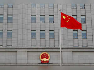 FILE PHOTO: A Chinese national flag waves outside Beijing No. 2 Intermediate People's Court where Australian writer Yang Hengjun is expected to face trial on espionage charges, in Beijing