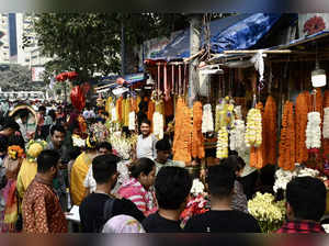 People buy flowers on the first day of the Bengali month of Falgun, which marks the start of the Spring season, at a flower market in Dhaka on February 14, 2024.