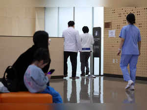 Medical workers walk at a hospital in Seoul