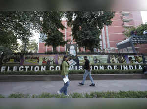 **EDS: TO GO WITH STORY** New Delhi: People walk past the Election Commission of...