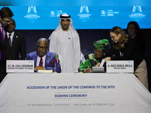 Director-General of the World Trade Organization (WTO) Ngozi Okonjo-Iweala and President of Comoros Azali Assoumani sign the agreement for the Comoros accession to the WTO during the 13th WTO Ministerial Conference in Abu Dhabi of February 26, 2024.