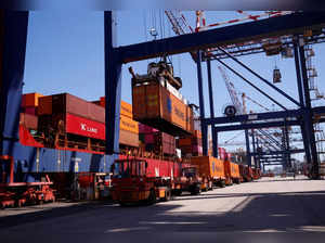 FILE PHOTO: Trucks deliver containers to be loaded onto a ship at the port in Durban