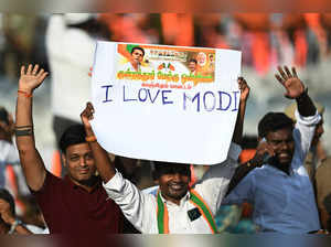 Barathtiya Janatha Party (BJP) supporters hold a placard reading 'I love Modi' during a public meeting attended by Indian Prime Minister Narendra Modi in Chennai on March 4, 2024.