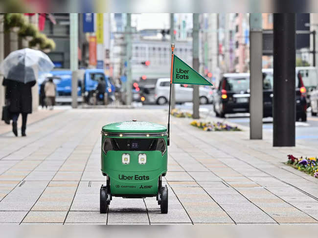 An unmanned robot navigates a street during a demonstration of a robot delivery service by Uber Eats Japan, Mitsubishi Electric and robot developer Cartken in downtown Tokyo on March 5, 2024.