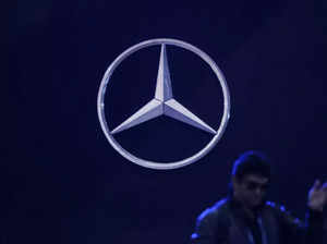 FILE PHOTO_ A man walks past the logo of Mercedes-Benz at a conference in New Delhi, India, Feb 1, 2024.