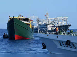 This photo taken on March 5, 2024 shows a vessel identified by the Philippine Coast Guard as “Chinese maritime militia” (back R) and a China Coast Guard vessel (front R) sailing near the Philippine military chartered Unaizah May 4 (L) during its supply mission to Second Thomas Shoal in the disputed South China Sea.