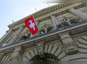 FILE PHOTO: The Swiss flag is seen on the Swiss Parliament house (Bundeshaus) in Bern