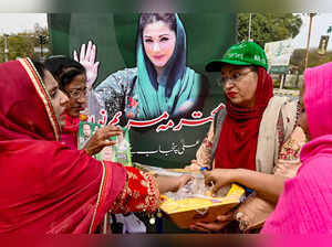 Women supporters and activists of Pakistan Muslim League Nawaz (PMLN) party distribute sweets to celebrate the appointment of Maryam Nawaz Sharif (C) as chief minister of Punjab province along a street in Lahore on February 27, 2024.