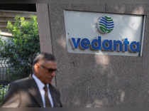 FILE PHOTO: A man walks past the logo of Vedanta outside its headquarters in Mumbai