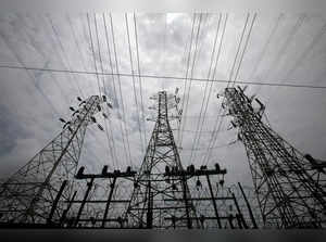 FILE PHOTO: High-tension power lines are pictured outside a Tata Power sub station in the suburbs of Mumbai