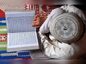 FILE PHOTO: A Muslim boy reads the Koran at a madrasa in Mathura