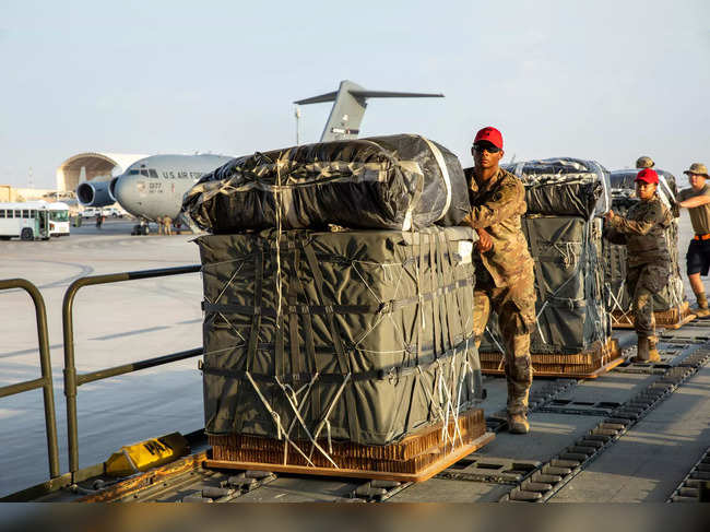 In this image obtained from the US Central Command (CENTCOM), military personnel load humanitarian aid into US Air Force C-130 planes at an undisclosed location on March 5, 2024, in a joint US-Jordan operation.