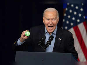President Joe Biden picks up a button thrown on stage that reads "Regulate Guns not Women" during a campaign event at Pullman Yards on March 9, 2024 in Atlanta, Georgia.