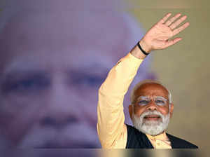 India's Prime Minister Narendra Modi greets his supporters on his arrival at the public meeting organised by Bharatiya Janata Party (BJP) in Barasat on the outskirts of Kolkata on March 6, 2024.