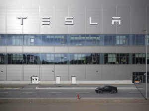 Production at Tesla's plant in Germany is halted after a power outage. Officials suspect arson