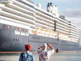 A tourist takes a photo of a cruise ship in Old San Juan, Puerto Rico