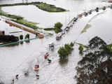 Vehicles drive through a flooded highway in the municipality of Chia, near Bogota