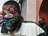 Protesters protect their faces against tear gas near Tahrir Square in Cairo