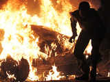 A protester runs after setting a fire during clashes with security forces in Alexandria