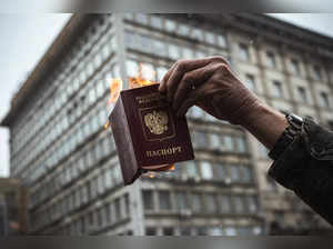A protester burns his Russian passport during a demonstration against Russia's military invasion on Ukraine, in Belgrade, on March 6, 2022, 11 days after Russia launched a military invasion on Ukraine.