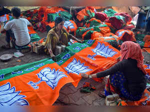 Mathura: Labourers make flags of Bharatiya Janata Party (BJP) ahead of the Lok S...