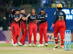New Delhi: RCB's Shreyanka Patil with teammates celebrates the wicket of DC's Me...