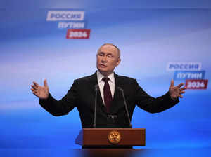Russian President Vladimir Putin speaks on a visit to his campaign headquarters ...