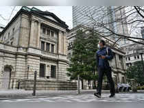 A man walks past the Bank of Japan (BoJ) headquarters complex in central Tokyo on March 19, 2024.
