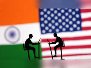 Illustration shows the Indian and U.S. flags and people miniatures