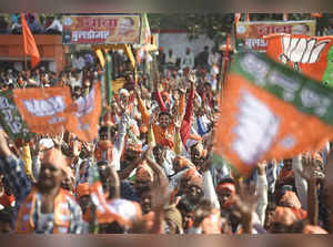 Gorakhpur: Supporters holding BJP flags, attend a public meeting UP Chief Minist...