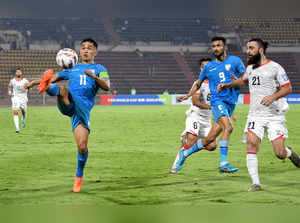 Guwahati, Mar 26 (ANI): India's Sunil Chhetri and Afghanistan's player vie for t...