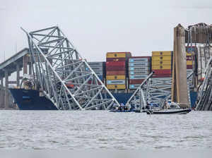 The collapsed Francis Scott Key Bridge lies on top of the container ship Dali in Baltimore, Maryland, on March 27, 2024.