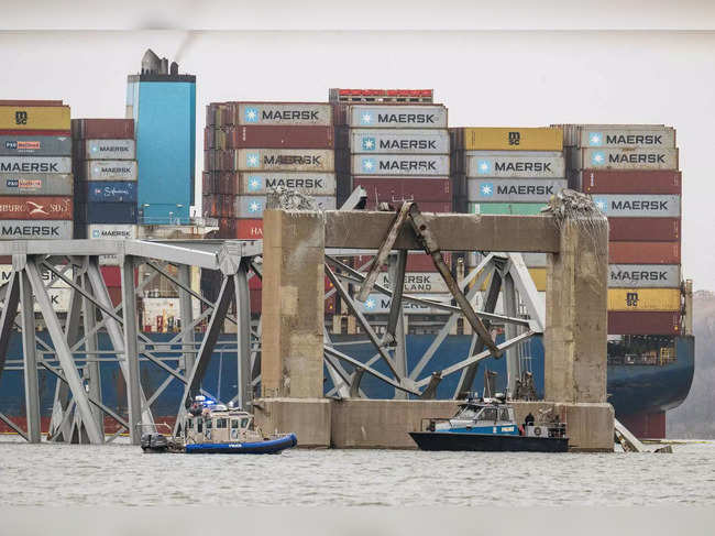 The collapsed Francis Scott Key Bridge lies on top of the container ship Dali in Baltimore, Maryland, on March 27, 2024.