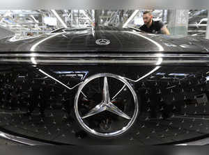 An employee of German car maker Mercedes-Benz works on an EQS passenger car at the 'Factory 56', a completely digitized assembly line, at the Mercedes-Benz manufacturing plant in Sindelfingen, southwestern Germany, on February 13, 2023.