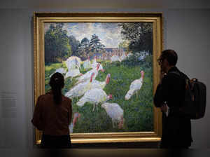 Visitors stand in front of the painting "Les Dindons" (The Turkeys - 1876) by French impressionist painter Claude Monet (1840-1926), during a visit of the exhibition 'Paris 1874 Inventing Impressionism' at the Musee d'Orsay in Paris on March 22, 2024, as 150 years ago, on April 15, 1874, the first impressionist exhibition opened in Paris.